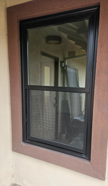 Milgard Black Trinsic Single Hung Window With Cut Down ZBar Flush Fin Between Wood Borders