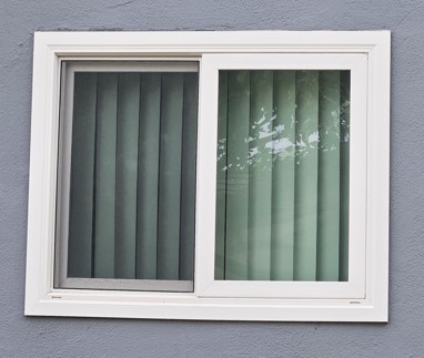 Milgard Style Line Horizontal Sliding Window In White Frame On Gray Stucco