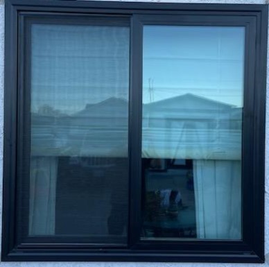 Milgard Trinsic horizontal Sliding Black Frame Window In Modern Kitchen